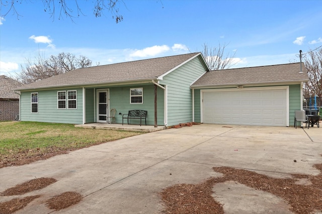 ranch-style house featuring a garage, covered porch, and a front lawn