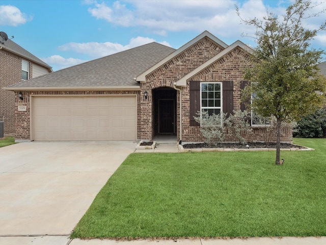 view of front of home with a garage and a front lawn