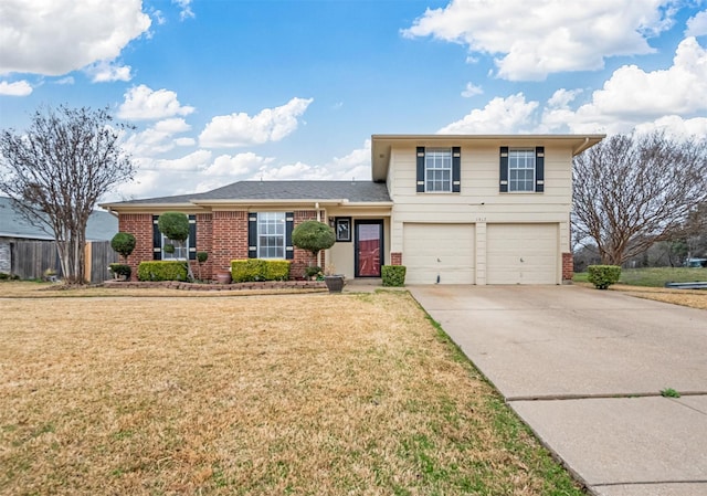 tri-level home with brick siding, a garage, driveway, and a front yard