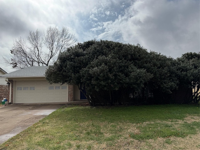 view of front of property with a front lawn and a garage