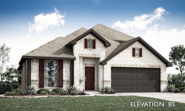 french country style house with a front yard and a garage