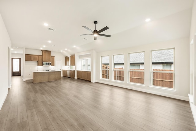 112 Woodlands Way, Balch Springs, TX 75181 - unfurnished living room with baseboards, ceiling fan, wood finished floors, vaulted ceiling, and recessed lighting