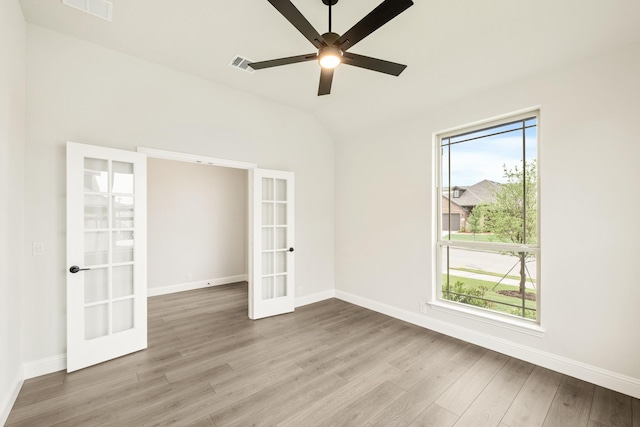 112 Woodlands Way, Balch Springs, TX 75181 - spare room featuring french doors, light wood-type flooring, baseboards, ceiling fan, and lofted ceiling