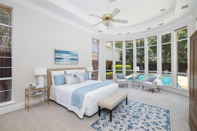 bedroom with a tray ceiling, ornamental molding, carpet flooring, and ceiling fan