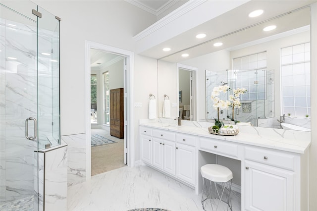 bathroom with vanity, an enclosed shower, and ornamental molding