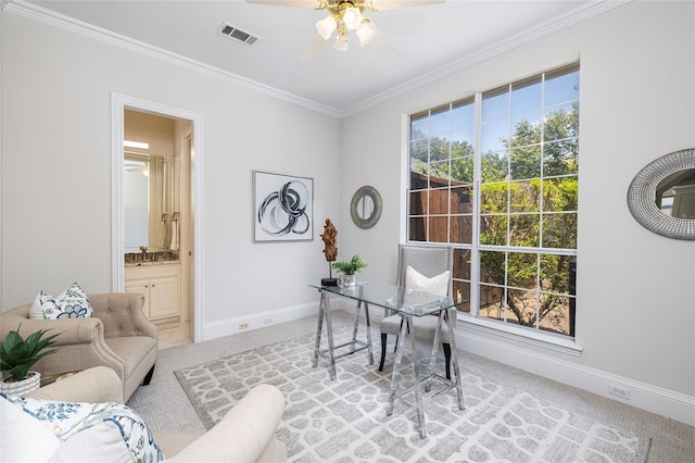 carpeted office space featuring ornamental molding and ceiling fan