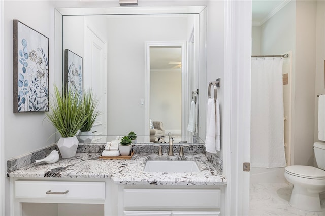 bathroom with ornamental molding, vanity, and toilet