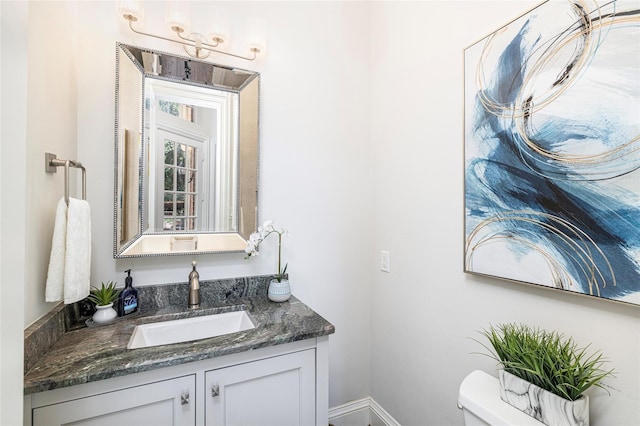 bathroom with toilet and vanity