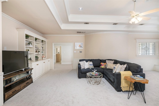 carpeted living room with ceiling fan, ornamental molding, and a raised ceiling