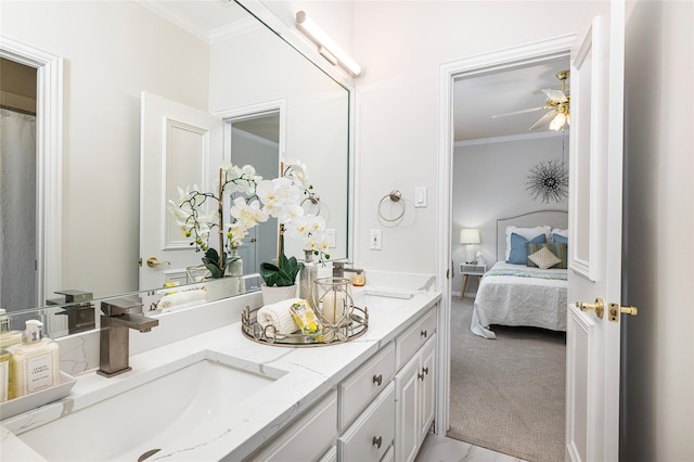 bathroom with ornamental molding, vanity, and ceiling fan