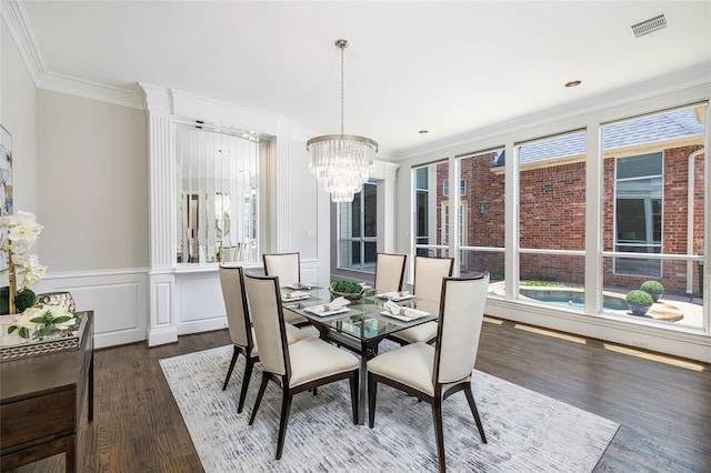 dining space featuring a chandelier, dark wood-style flooring, visible vents, and crown molding