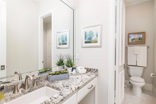 bathroom featuring vanity and toilet