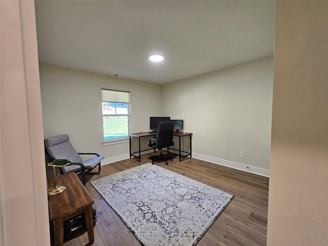 home office with wood finished floors and baseboards