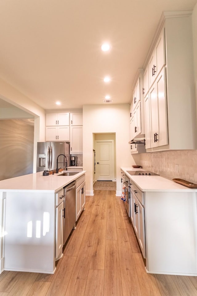 2040 Bluff Creek Dr, Strawn, TX 76475 - kitchen with light countertops, appliances with stainless steel finishes, decorative backsplash, and a sink
