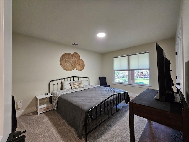 bedroom with carpet floors, visible vents, and baseboards