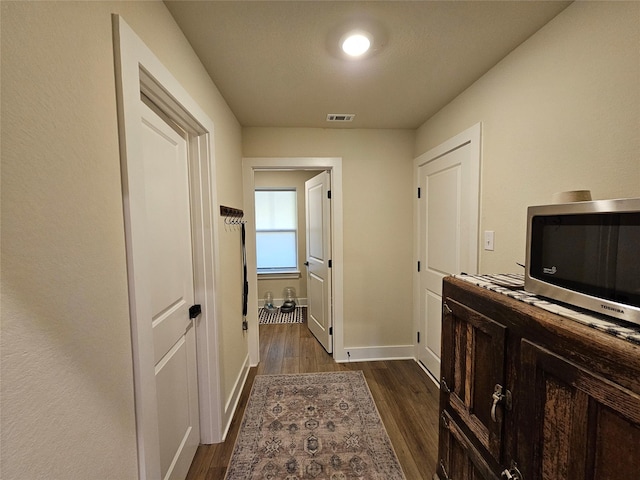 2040 Bluff Creek Dr, Strawn, TX 76475 - corridor with visible vents, dark wood-style flooring, and baseboards