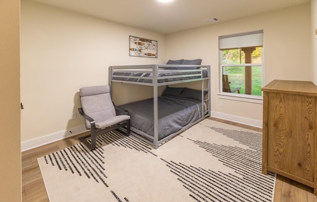 2040 Bluff Creek Dr, Strawn, TX 76475 - bedroom featuring baseboards, visible vents, and wood finished floors