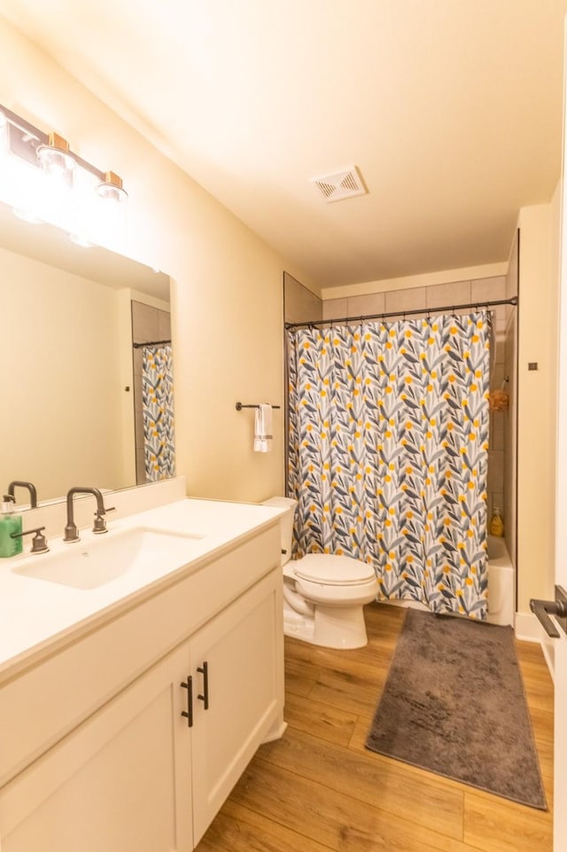 2040 Bluff Creek Dr, Strawn, TX 76475 - bathroom featuring toilet, visible vents, wood finished floors, and vanity