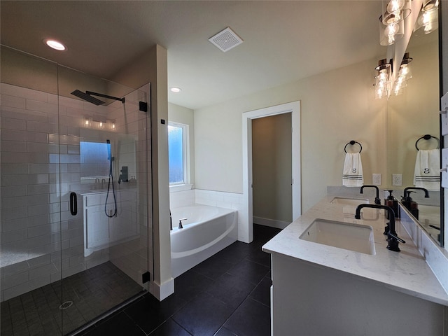 full bathroom featuring double vanity, visible vents, tile patterned floors, a sink, and a bath