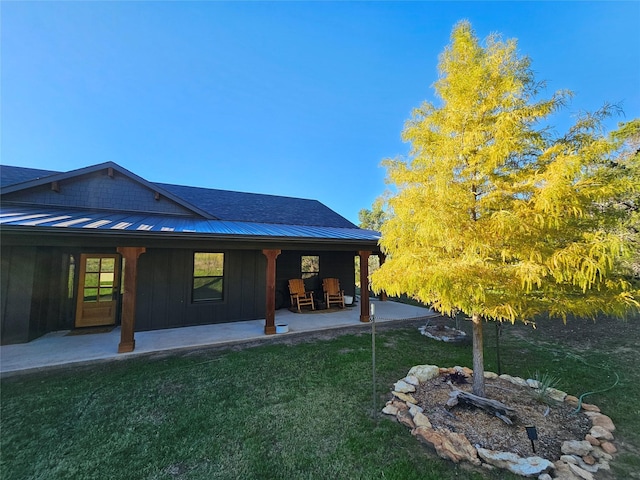 2040 Bluff Creek Dr, Strawn, TX 76475 - rear view of property featuring board and batten siding, a standing seam roof, metal roof, a lawn, and a patio