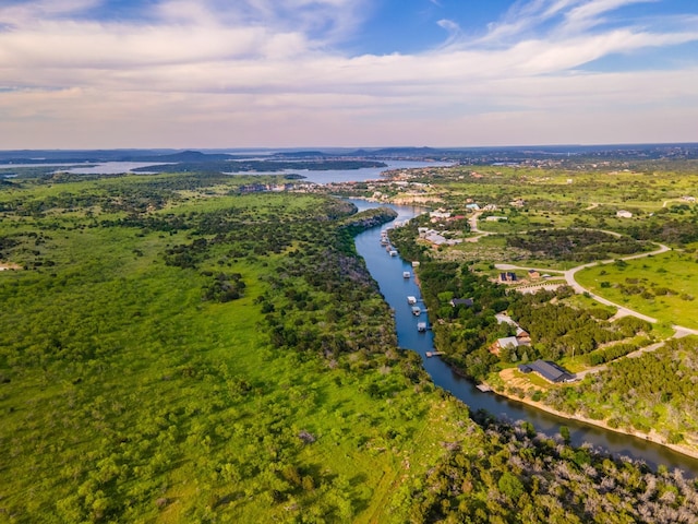 aerial view at dusk featuring a water view