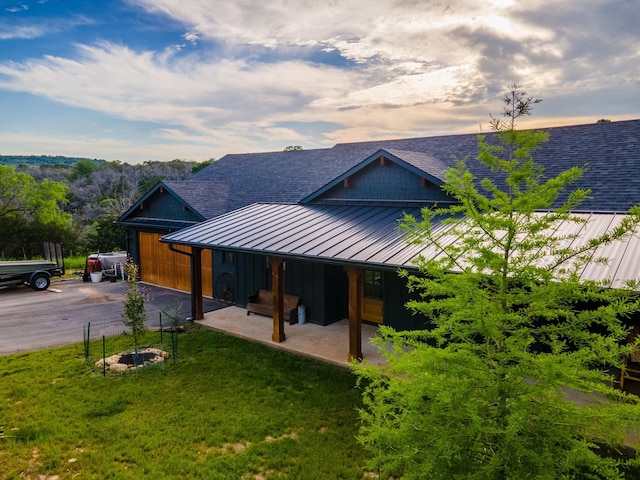 2040 Bluff Creek Dr, Strawn, TX 76475 - exterior space featuring driveway, a standing seam roof, a shingled roof, metal roof, and a yard