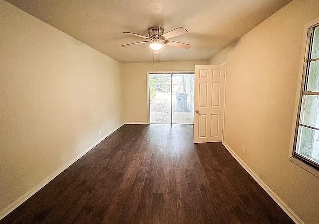 spare room with dark wood-type flooring and ceiling fan