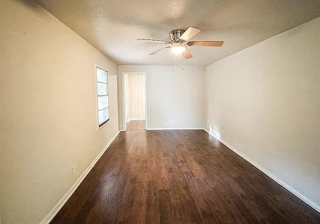 empty room featuring ceiling fan and dark hardwood / wood-style flooring