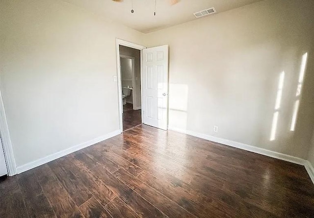 empty room with ceiling fan and dark hardwood / wood-style floors