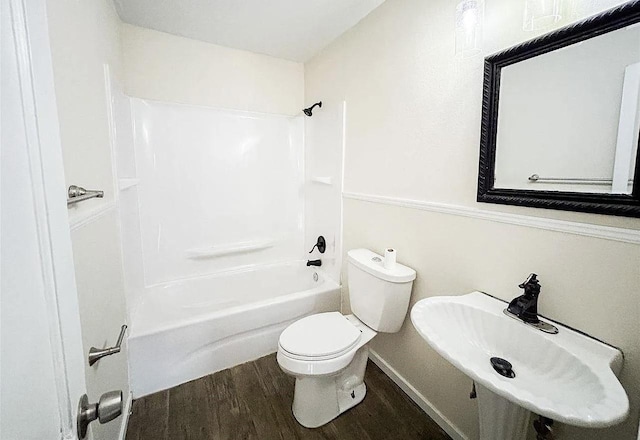 full bathroom featuring wood-type flooring, toilet, sink, and tub / shower combination