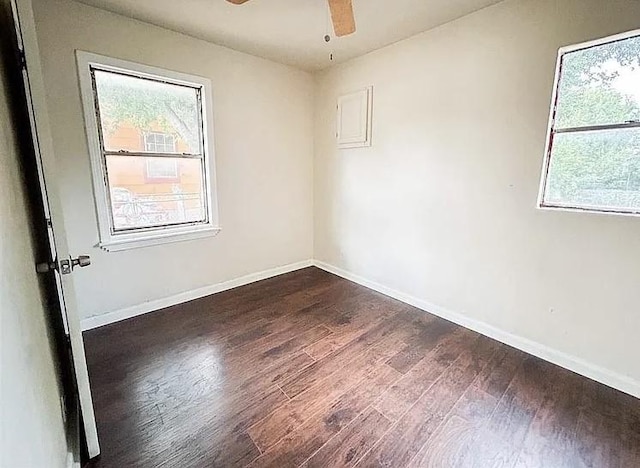 unfurnished room featuring dark wood-type flooring and ceiling fan