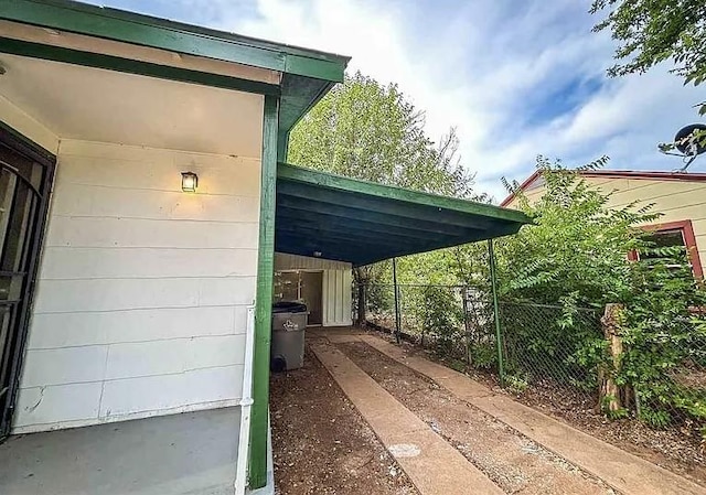 view of vehicle parking featuring a carport