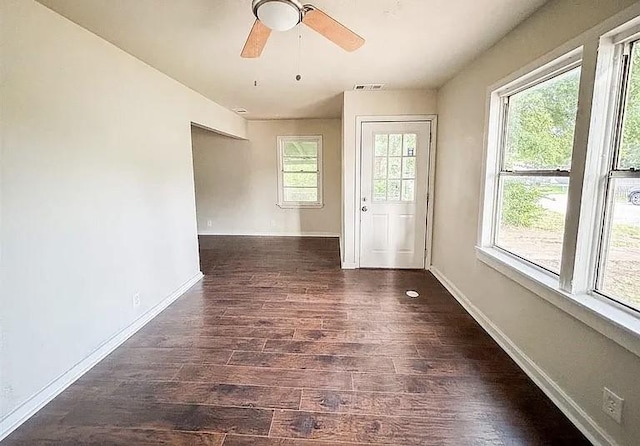 spare room with ceiling fan and dark wood-type flooring