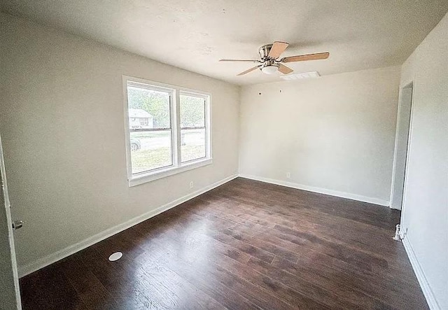 unfurnished room with ceiling fan and dark wood-type flooring