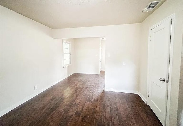 unfurnished room featuring dark hardwood / wood-style flooring