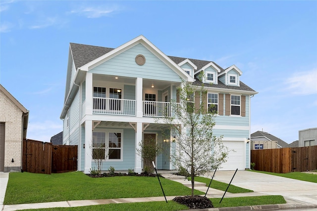 5038 Duck Cove Cir, Royse City, TX 75189 - view of front facade with a balcony, concrete driveway, an attached garage, a shingled roof, and covered porch