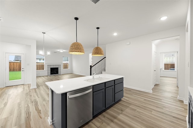 5038 Duck Cove Cir, Royse City, TX 75189 - kitchen featuring stainless steel dishwasher, a sink, healthy amount of natural light, light wood-style floors, and recessed lighting
