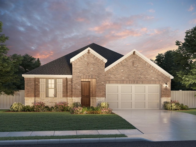 view of front of house featuring a garage and a lawn