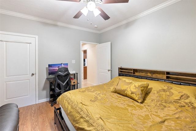 bedroom with baseboards, a ceiling fan, light wood-style flooring, and crown molding