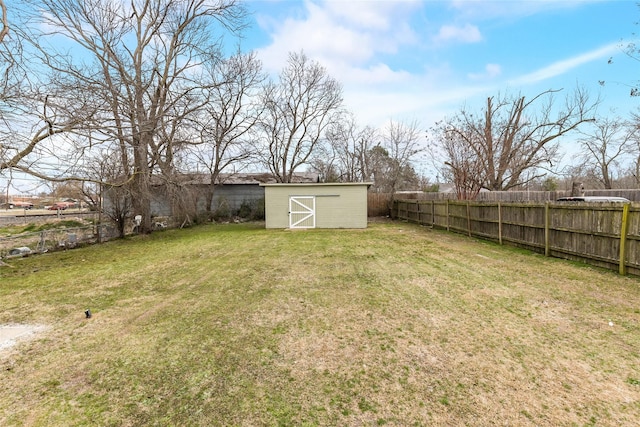 view of yard with fence, an outdoor structure, and a shed