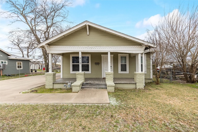 bungalow with fence, a porch, and a front yard