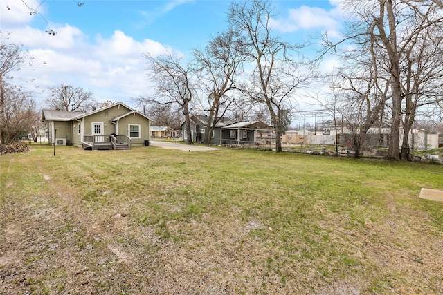 view of yard featuring fence and a deck