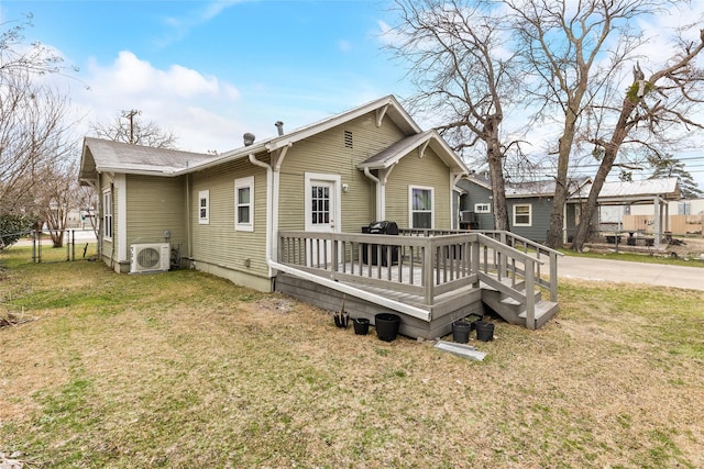 back of house featuring fence, a wooden deck, ac unit, and a yard