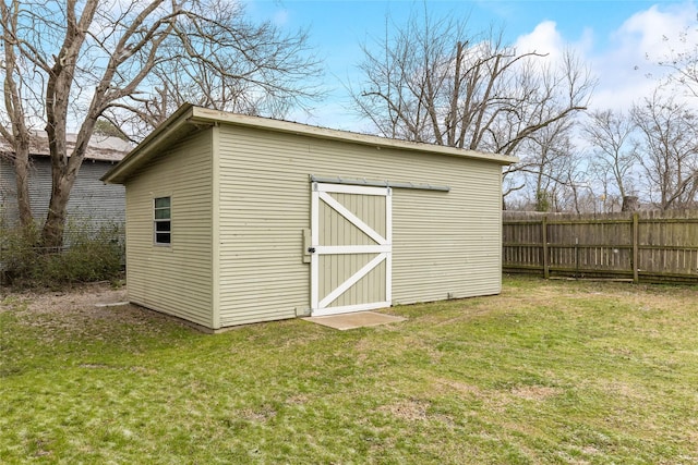 view of shed featuring fence