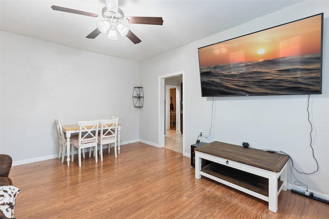 dining room featuring ceiling fan, baseboards, and wood finished floors