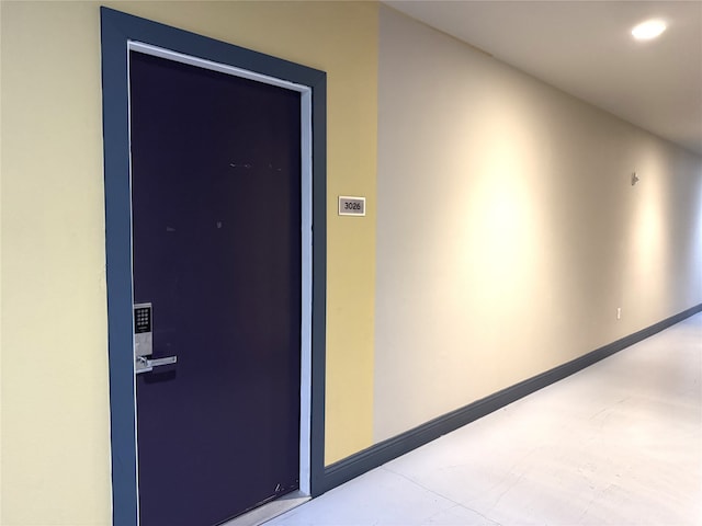 corridor featuring baseboards and recessed lighting