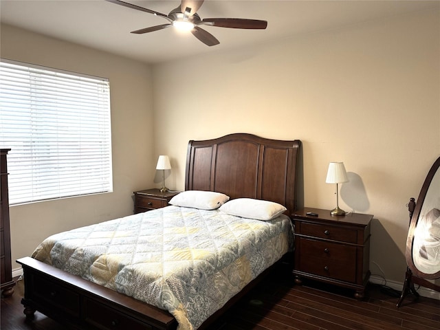 bedroom with ceiling fan, baseboards, and dark wood-style flooring