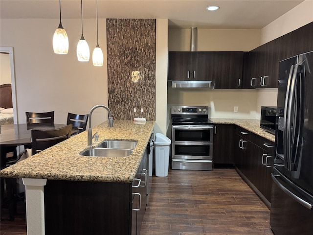 kitchen featuring dark wood-style flooring, a sink, a peninsula, under cabinet range hood, and black appliances