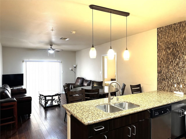 kitchen with visible vents, stainless steel dishwasher, dark wood-type flooring, open floor plan, and a sink