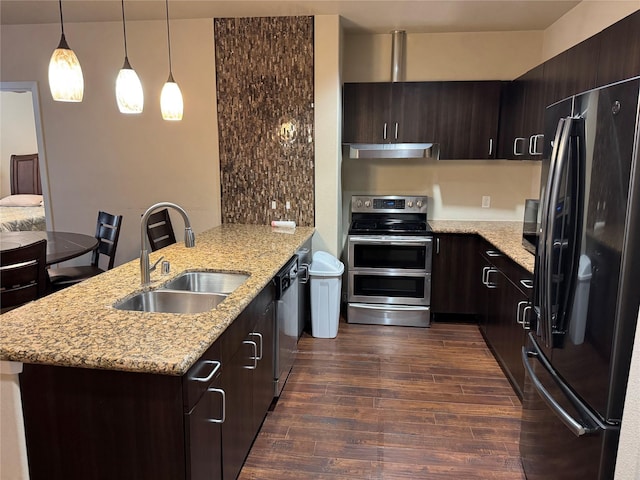 kitchen with dark brown cabinetry, a peninsula, under cabinet range hood, black appliances, and a sink